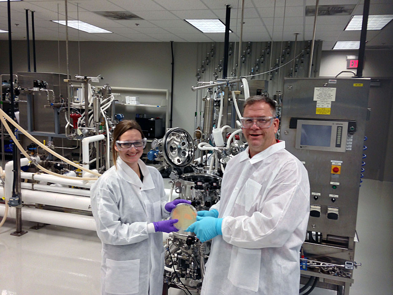 Ginger Krieg Dosier and Rick Lawless show a culture plate with bacterial cells grown at BTEC.